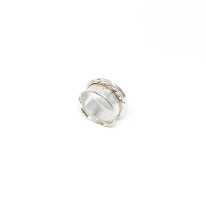 Hammered sterling silver spinner ring with a textured, movable outer band.