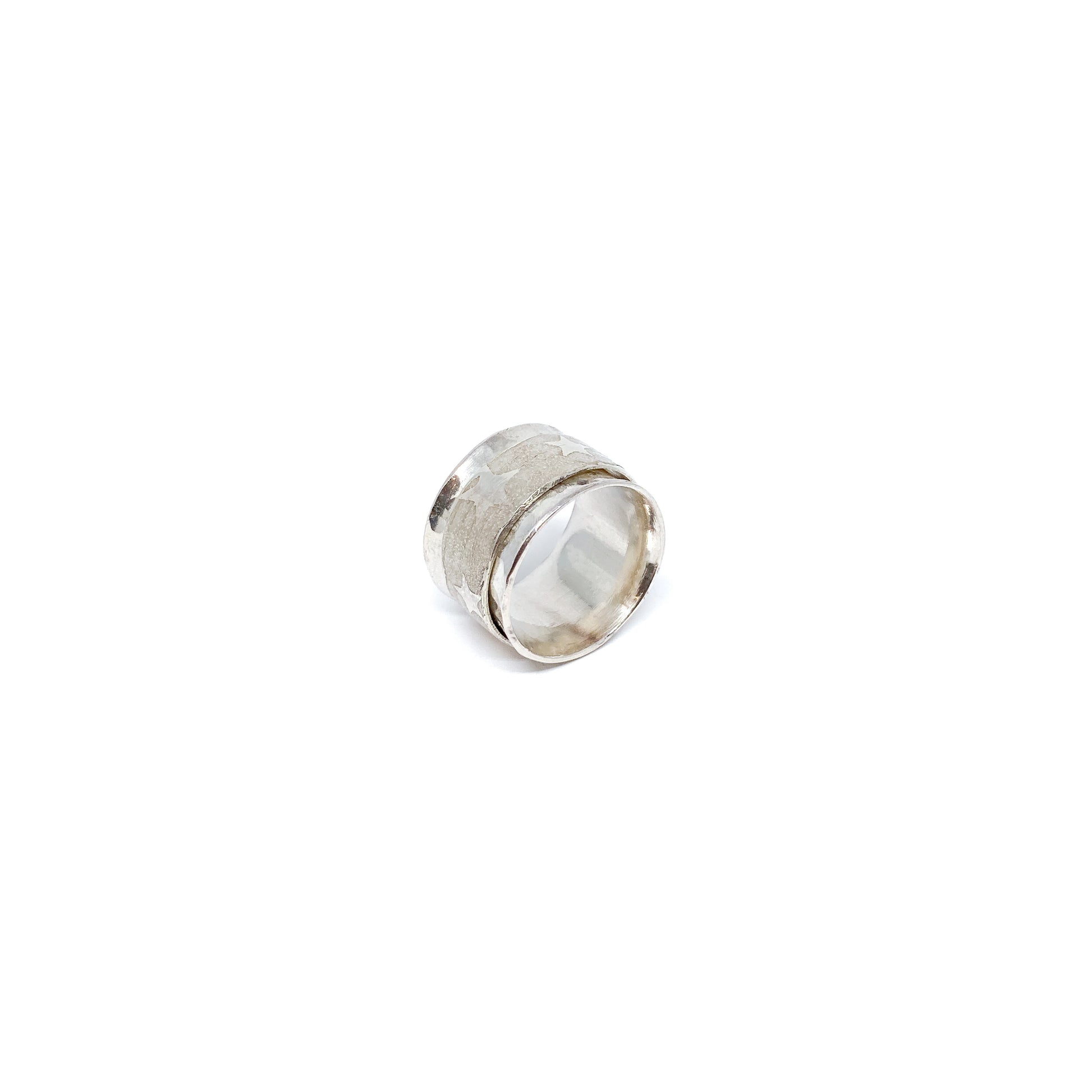 Textured silver spinner ring featuring a band with subtle star etchings.