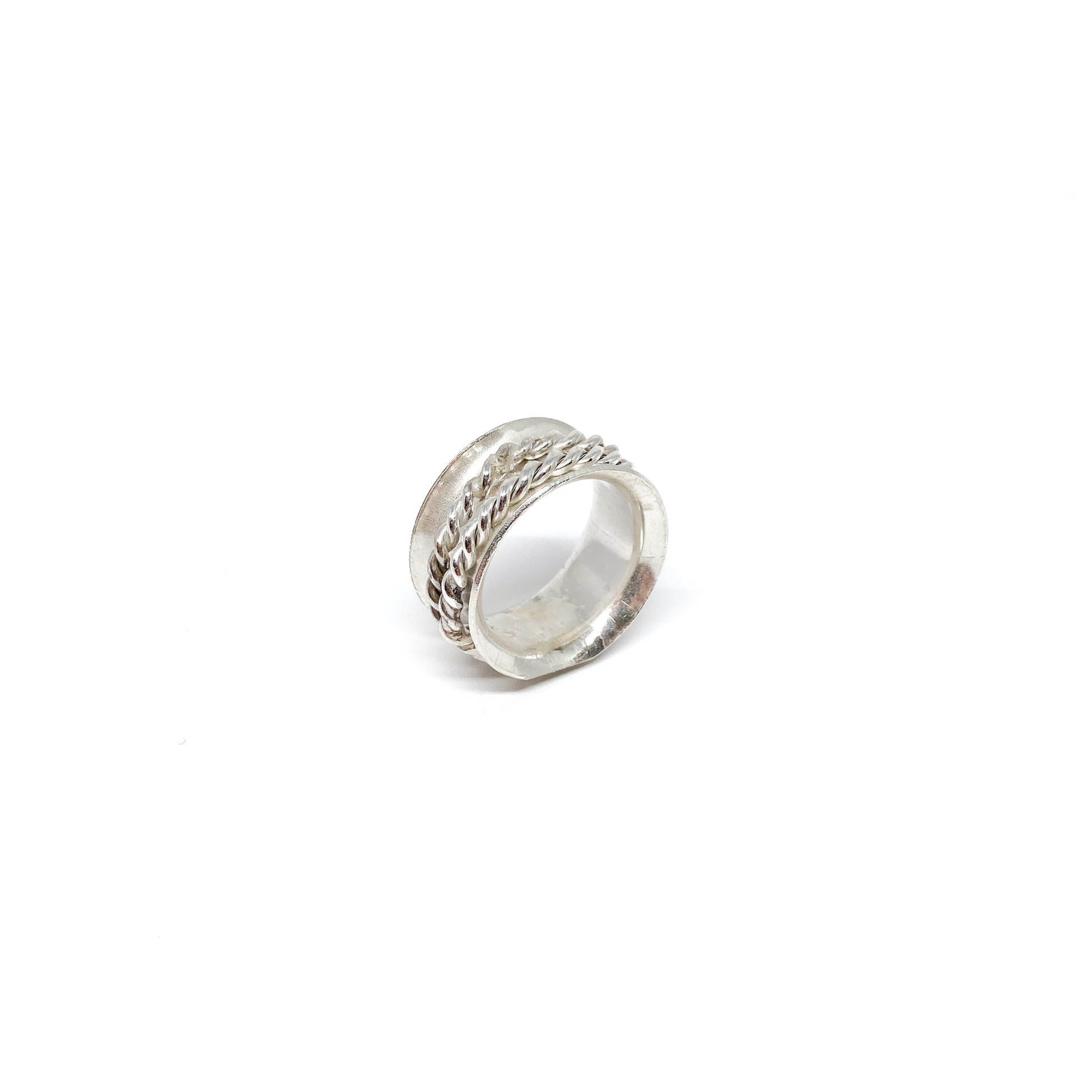 Textured silver spinner ring with a central braided band detail.