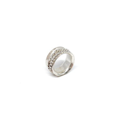 Textured silver spinner ring with a central braided band detail.