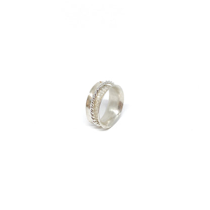 Silver spinner ring featuring a textured band and a delicate braided detail.