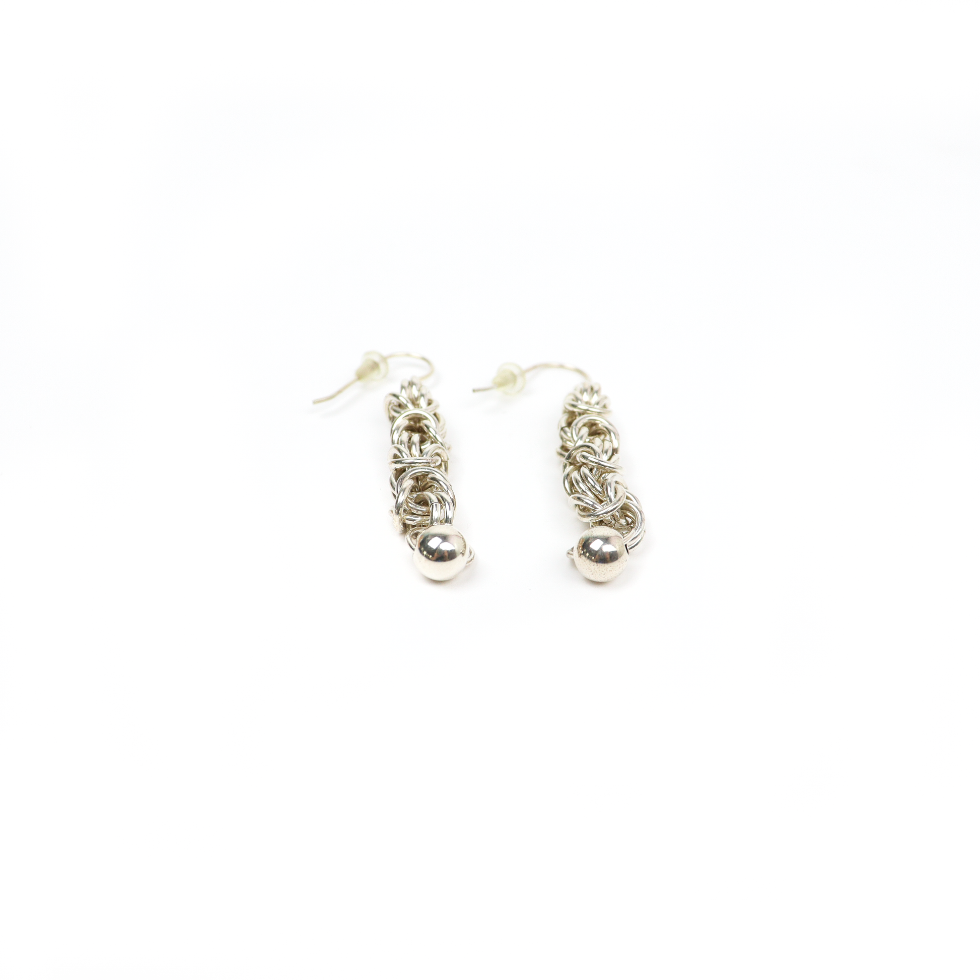 Pair of King Chain Dangle Earrings with small silver balls, laid flat to show detailed weaving.