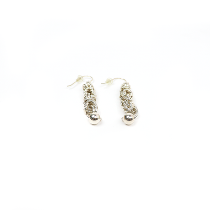 Pair of King Chain Dangle Earrings with small silver balls, laid flat to show detailed weaving.