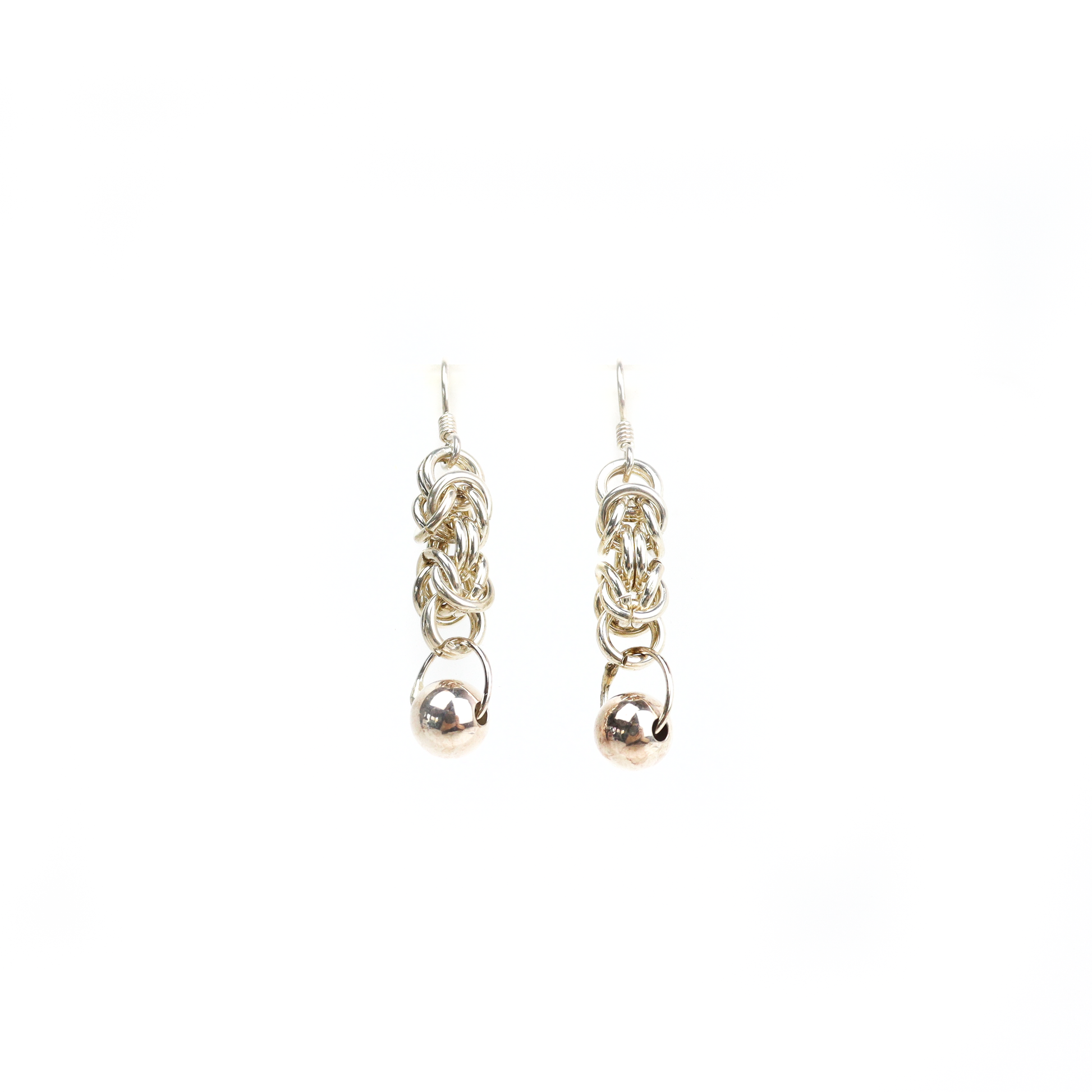 Straight view of King Chain Dangle Earrings showing woven silver links ending in a polished ball charm.