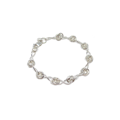 Infinity Knot Bracelet featuring interwoven rings and sleek links in a circular arrangement.
