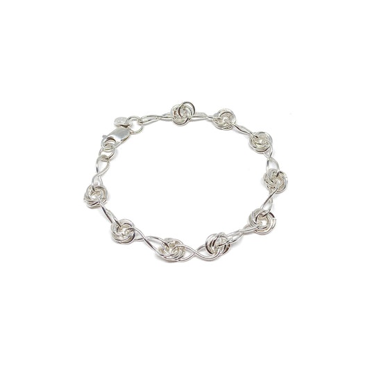 Infinity Knot Bracelet featuring interwoven rings and sleek links in a circular arrangement.