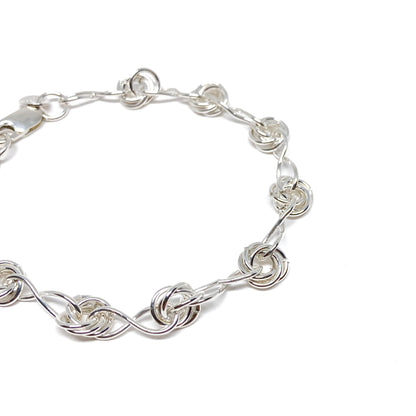 Close-up view of Infinity Knot Bracelet showcasing detailed twisted rings and interlocking links.