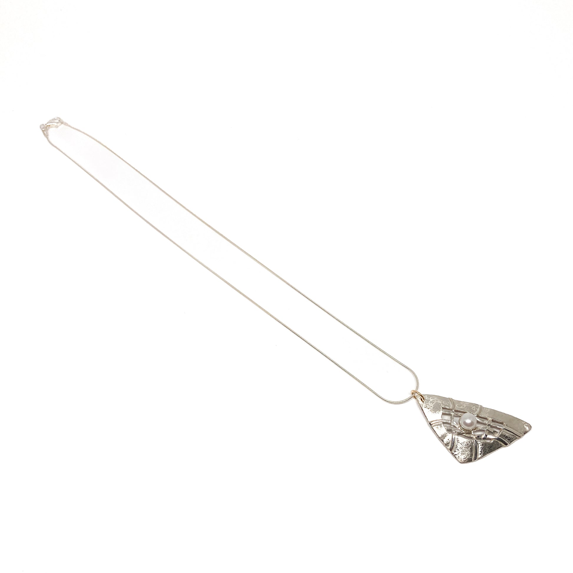 A silver pendant necklace with a triangular design, woven silver details, and a pearl accent. The pendant hangs from a delicate silver chain.