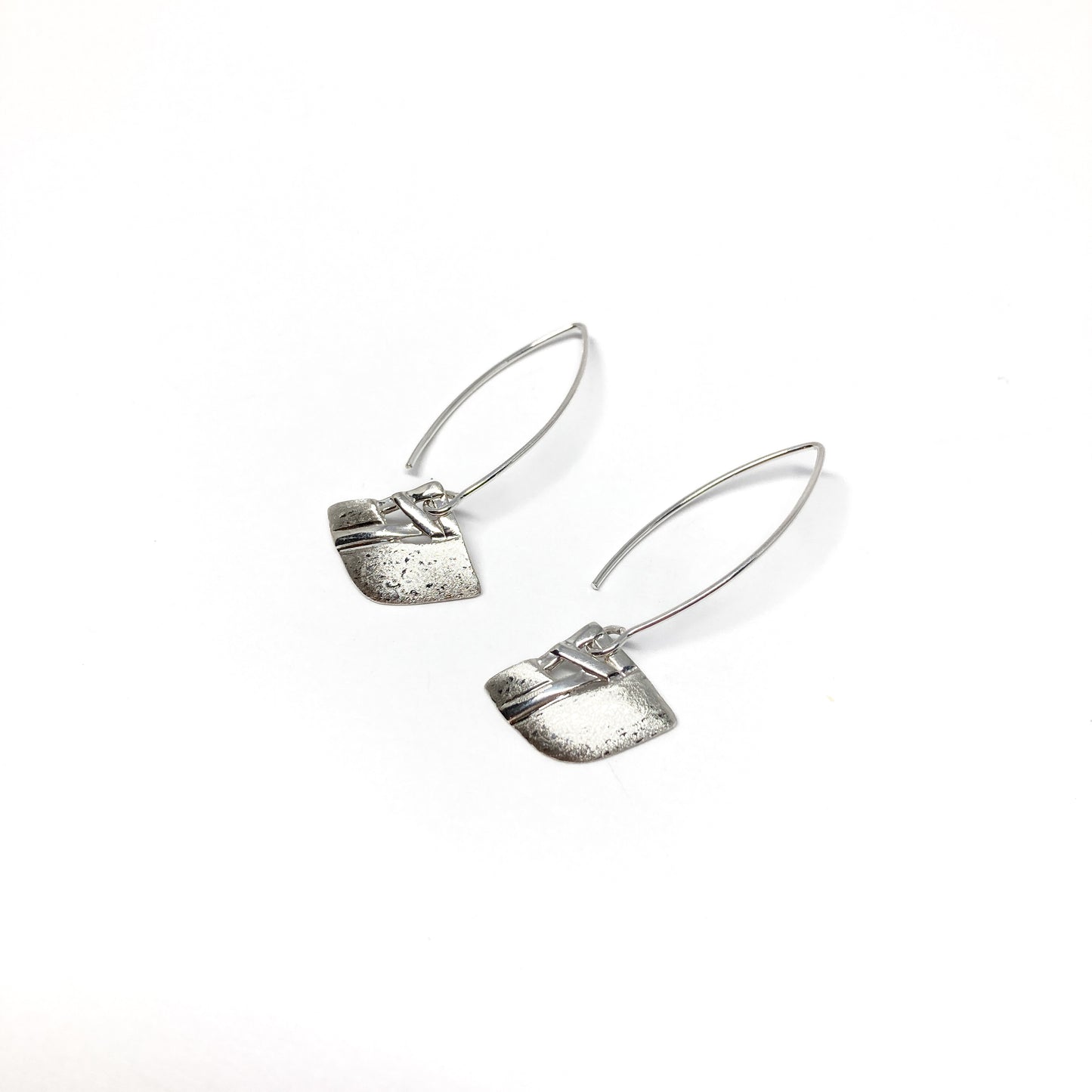 A pair of silver dangle earrings with a square woven design and a long, curved hook closure. The earrings have a textured finish.