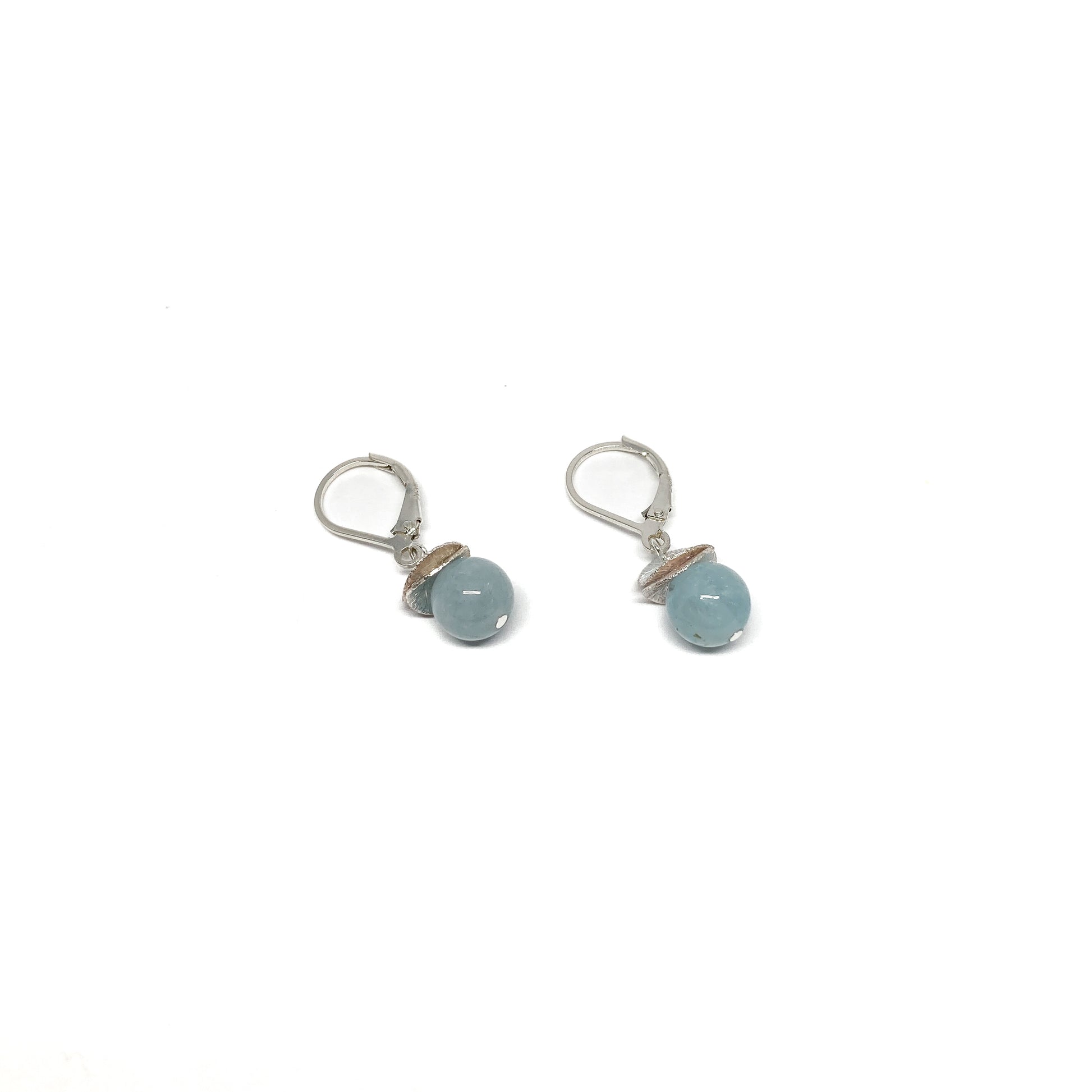 A pair of silver lever-back earrings with light blue beads and a textured, petal-like design. The earrings have a secure lever closure.