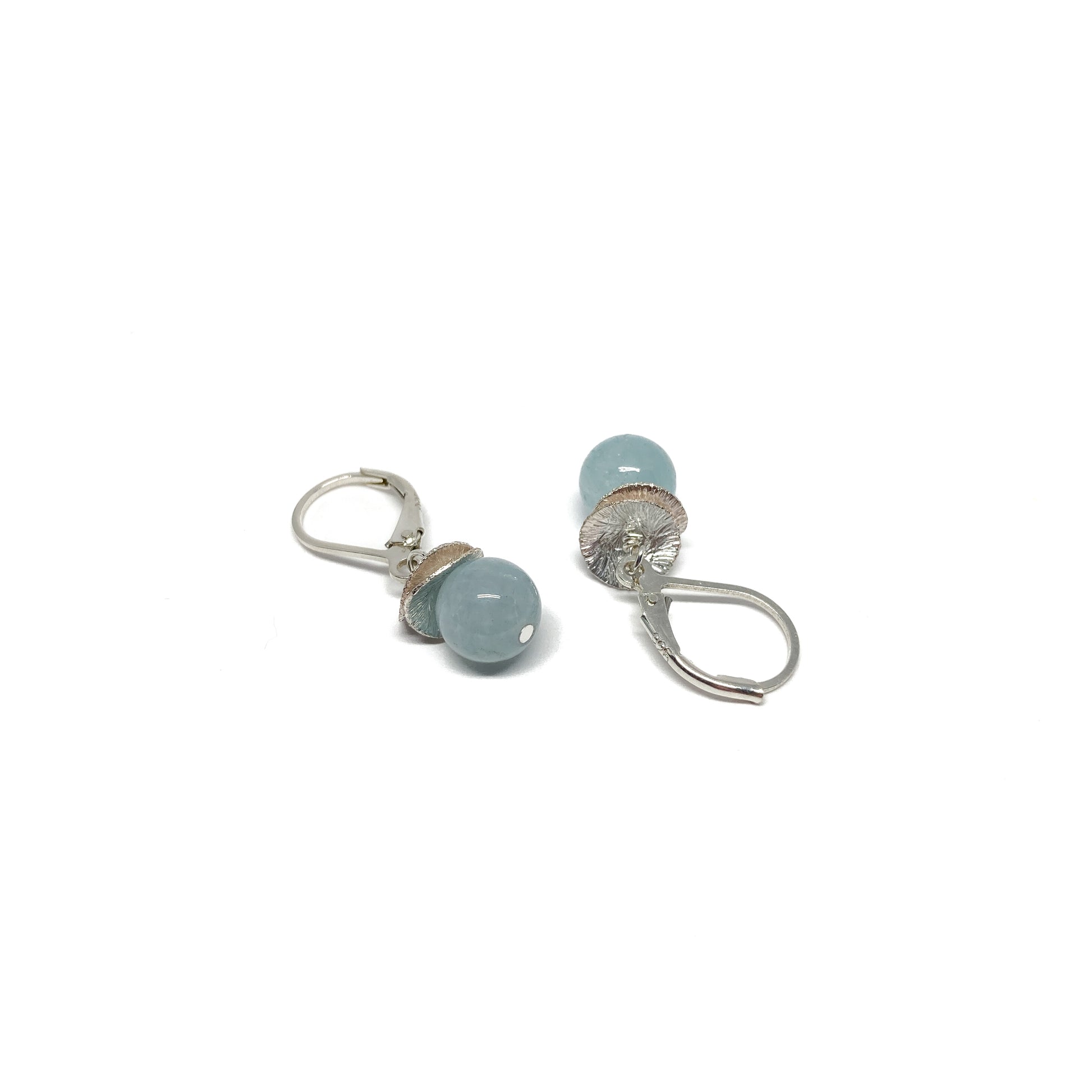 A pair of silver lever-back earrings with light blue beads and a textured, petal-like design. The earrings have a secure lever closure.