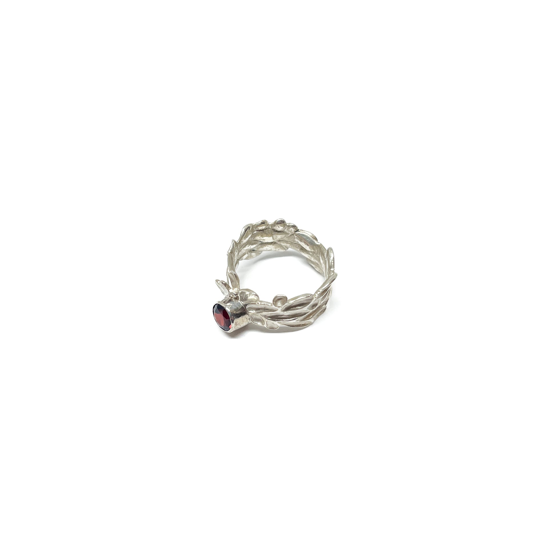 Textured sterling silver Twig and Leaf Engagement Ring with a single, round deep red garnet gemstone.