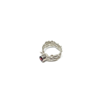 Textured sterling silver Twig and Leaf Engagement Ring with a single, round deep red garnet gemstone.