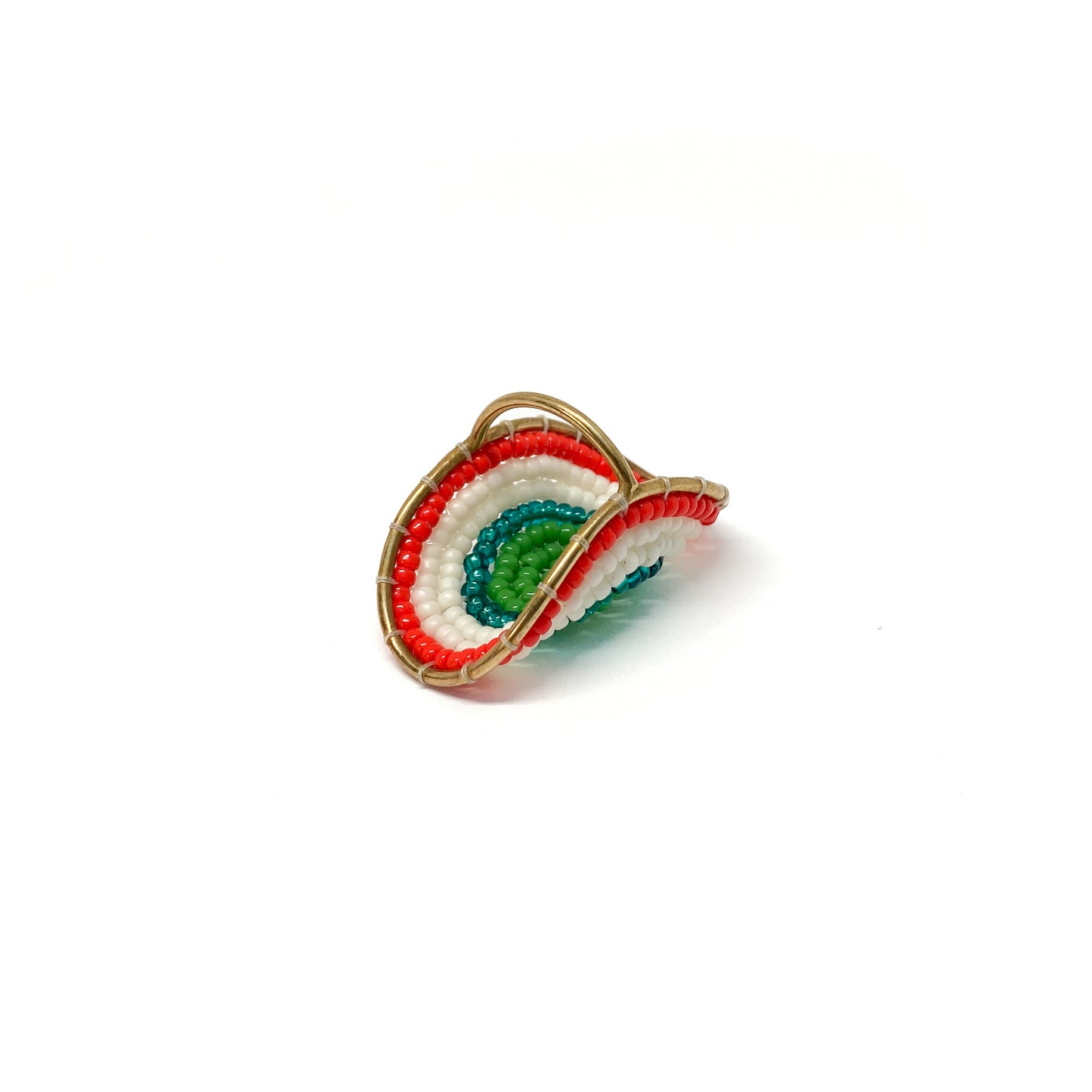 A gold ring showcases concentric arcs of green, teal, white, and red beads, creating a colorful, layered effect.