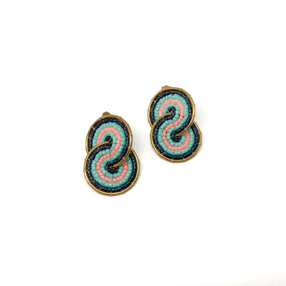 Two gold-toned clip-on earrings feature a figure-eight design intricately filled with pink, teal, and dark blue beads.