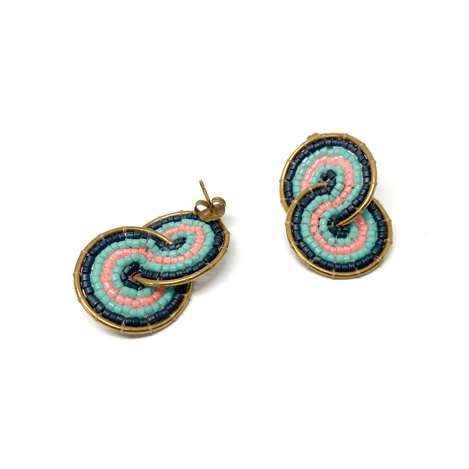 Two gold-toned earrings, one a stud and one a clip-on, feature a figure-eight design with pink, teal, and dark blue beads.