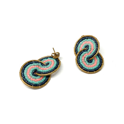 Two gold-toned earrings, one a stud and one a clip-on, feature a figure-eight design with pink, teal, and dark blue beads.