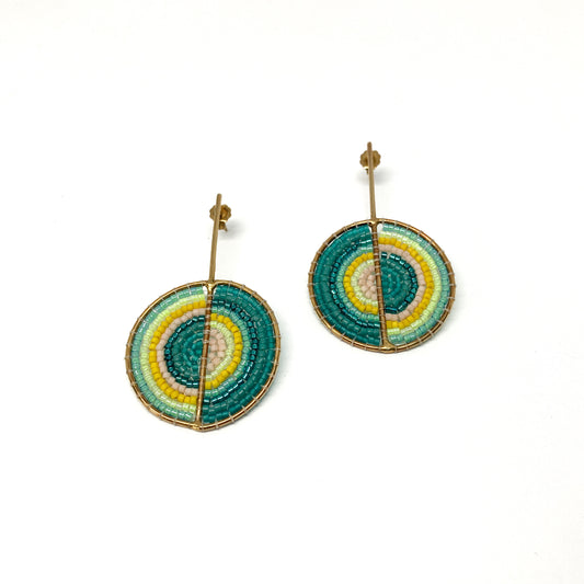 Two gold-toned stud earrings feature circular designs intricately filled with teal, yellow, light green, and pink beads.