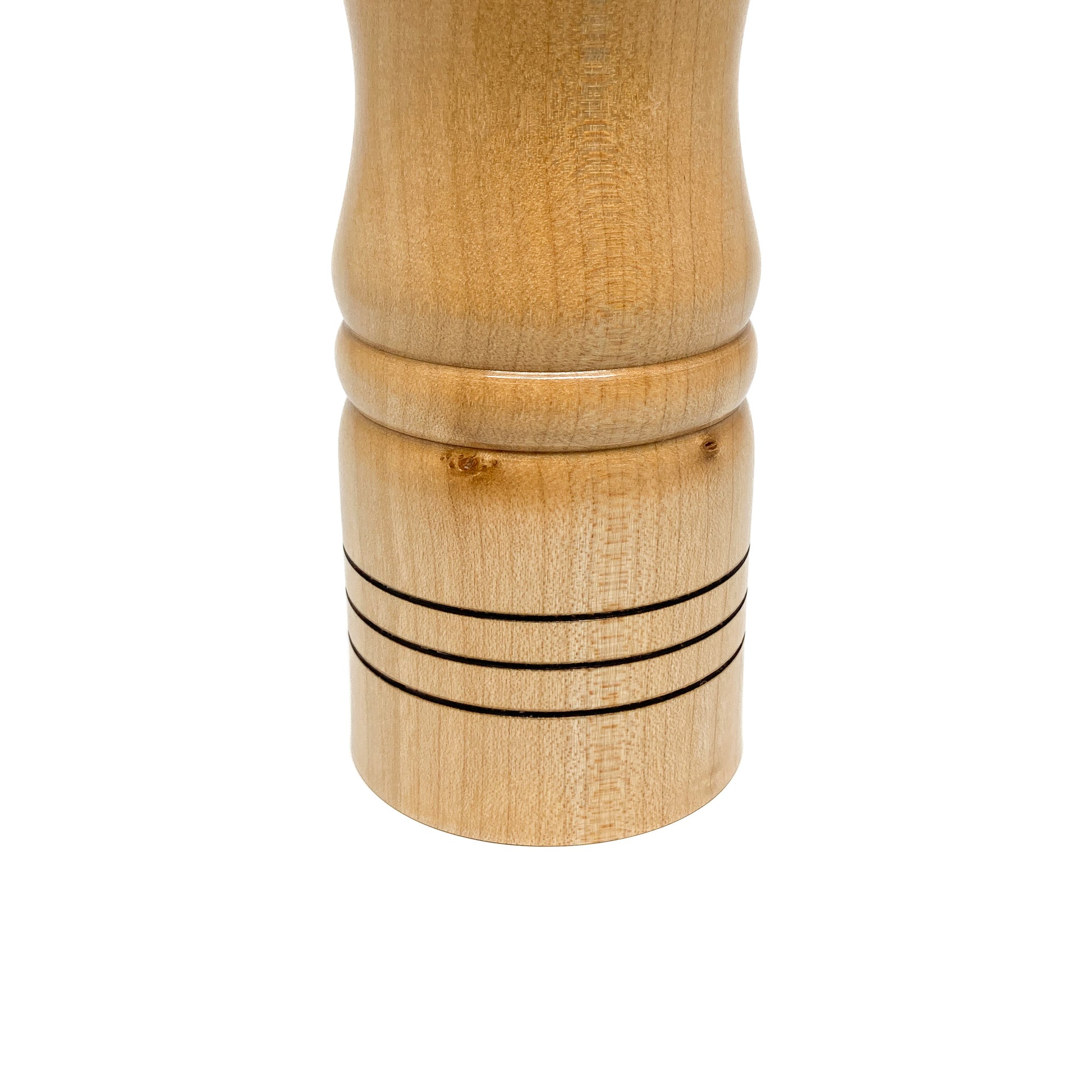 Wooden pepper mill base, light wood with ring details, close-up.