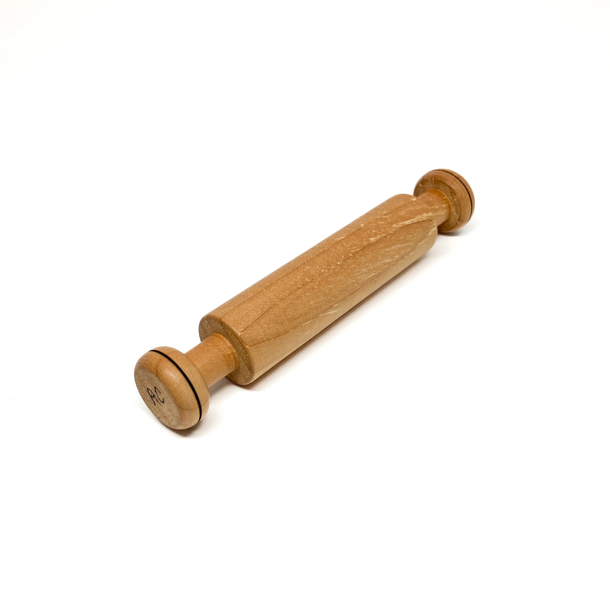 Angled view of a light wood rolling pin with "AC" on the handle.