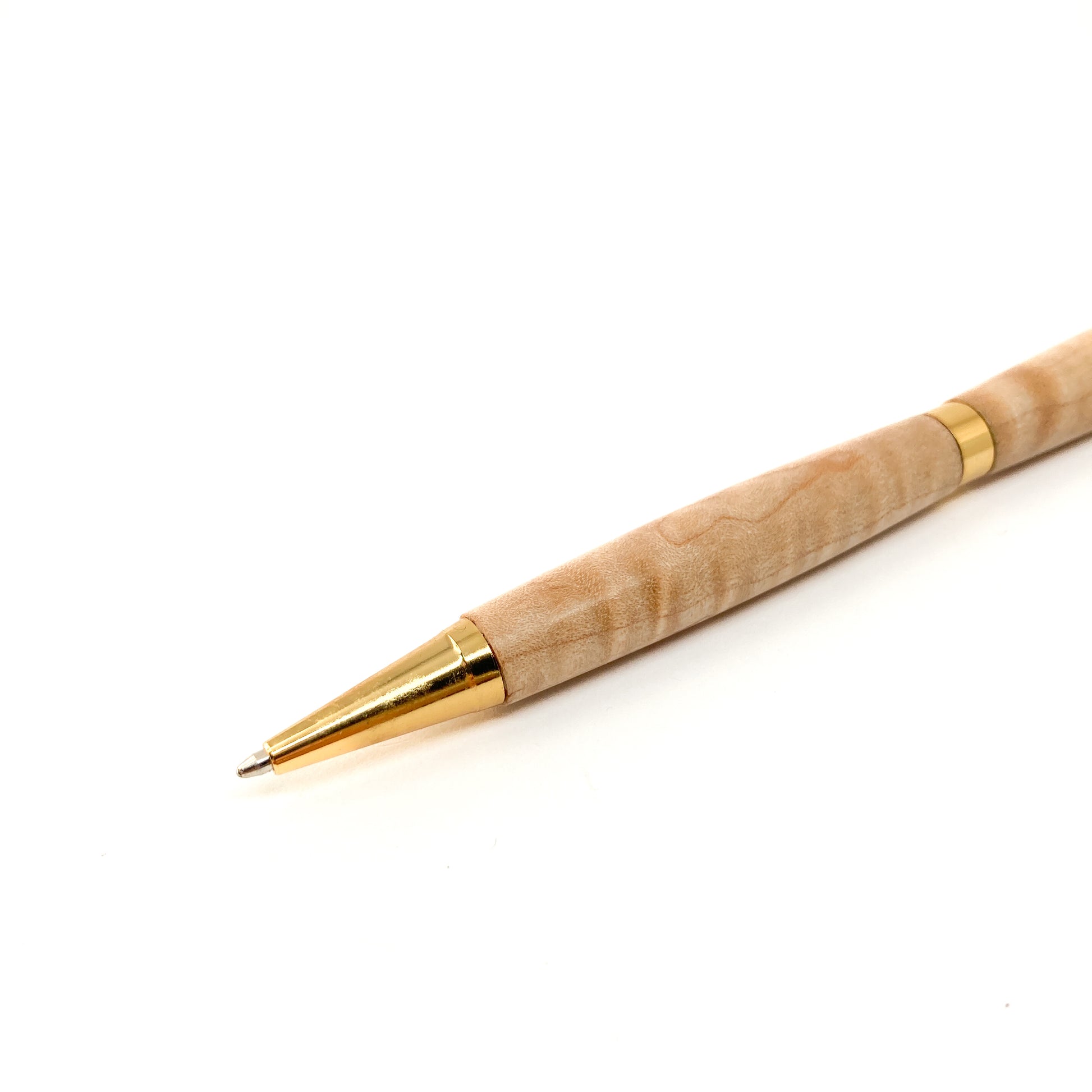 Light wood pen with gold tip, close-up view.