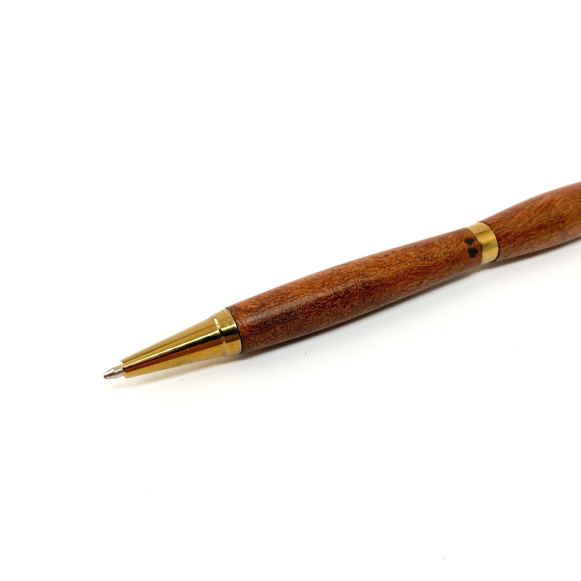Dark wood pen with gold tip, close-up view.