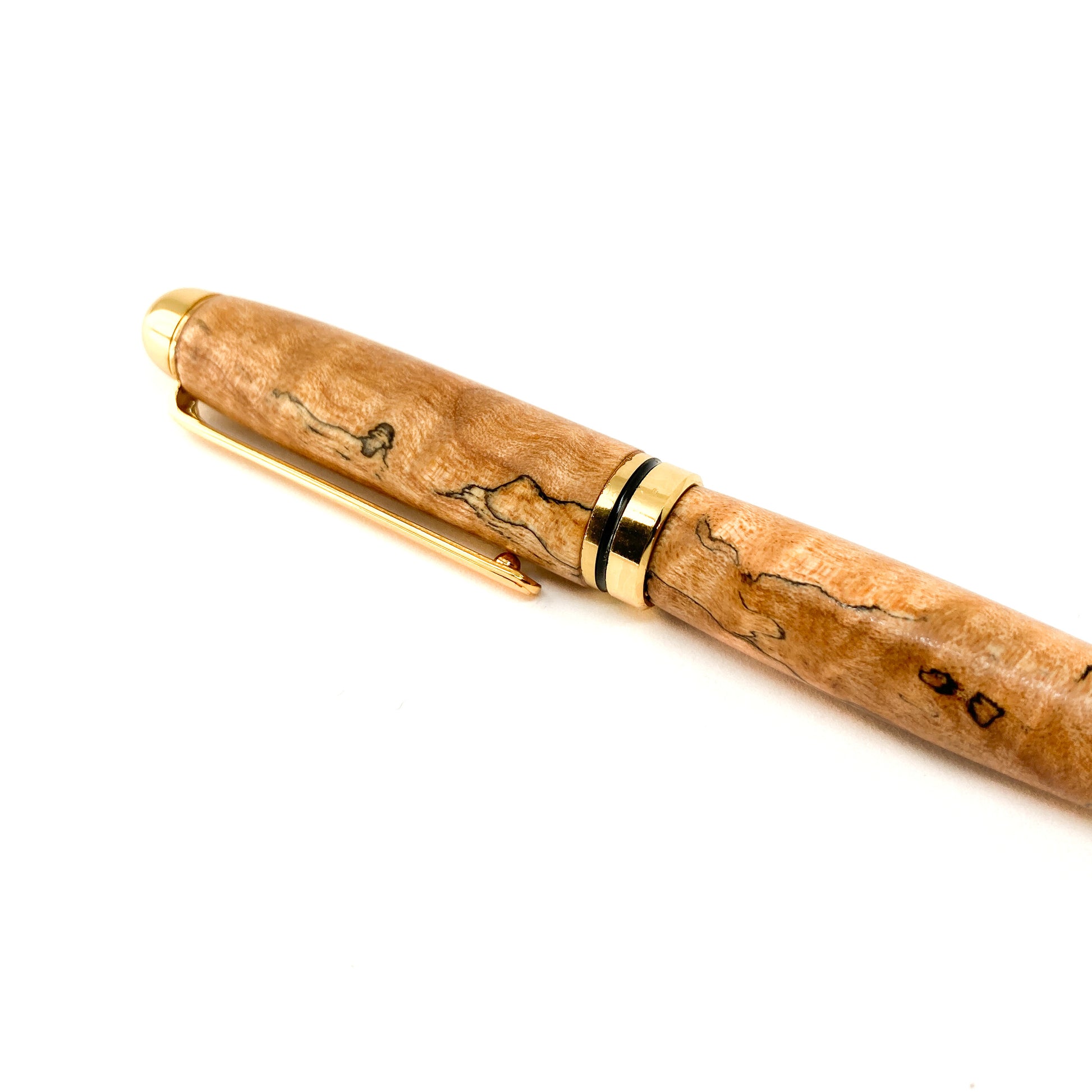 Burl wood pen with gold trim and clip, close-up view.