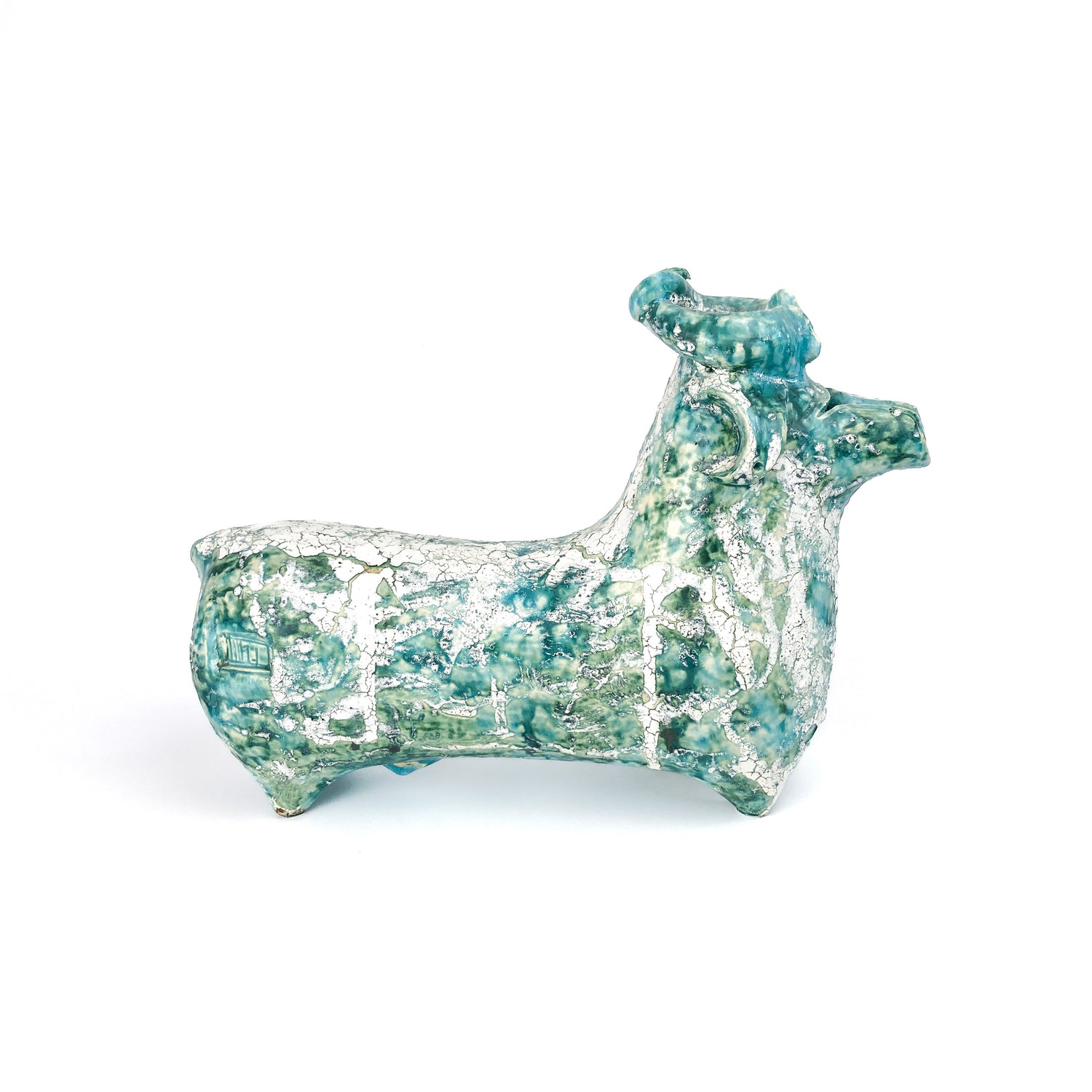 A teal and white textured ceramic bull figurine by Iraj Dashti-Laali with a raised head and curled horns.
