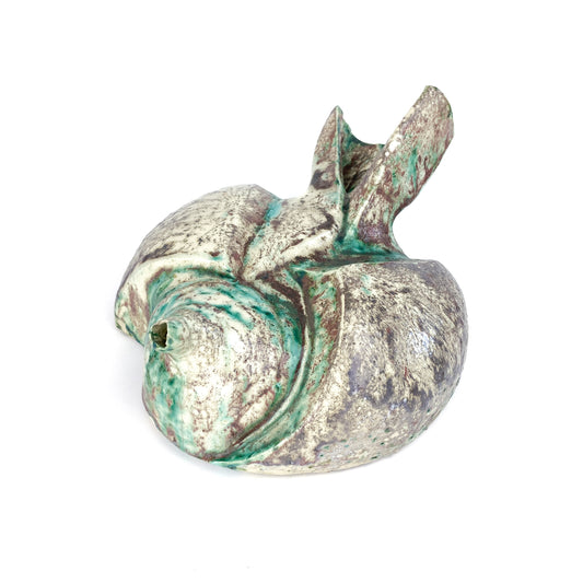 Bottom view of a ceramic oil lamp sculpture showing a signature mark and the textured, dripped multi-toned glaze.