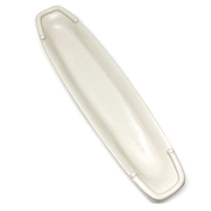 A long, narrow, white olive dish with raised details at each end.