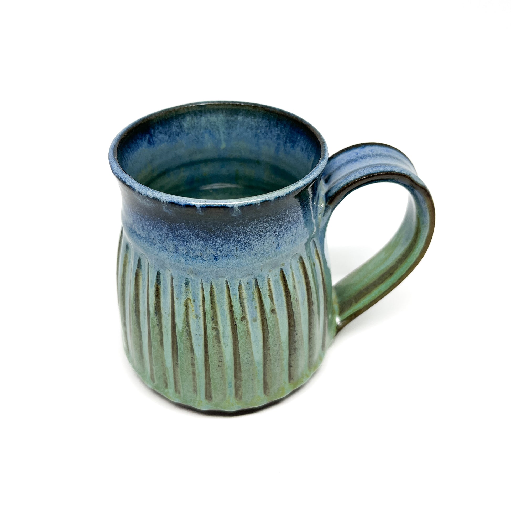 A ceramic mug with a ridged texture and a blue-to-green gradient.