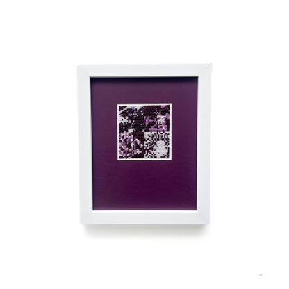 Straight-on view of the framed “Purple Monochrome” cross-stitch art.