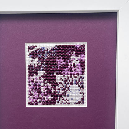 Close-up of the “Purple Monochrome” cross-stitch pattern inside the white frame.