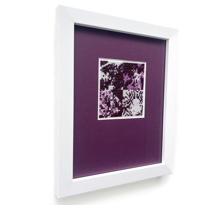 Angled view of the framed “Purple Monochrome” cross-stitch highlighting depth.