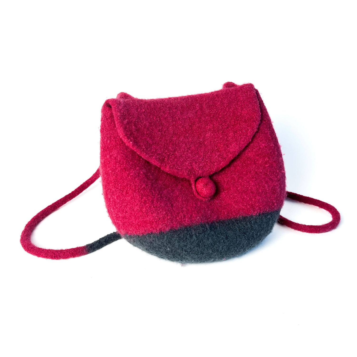 Two-tone felted backpack with a flap closure, button detail, and thin shoulder straps. The upper portion is a vibrant color.