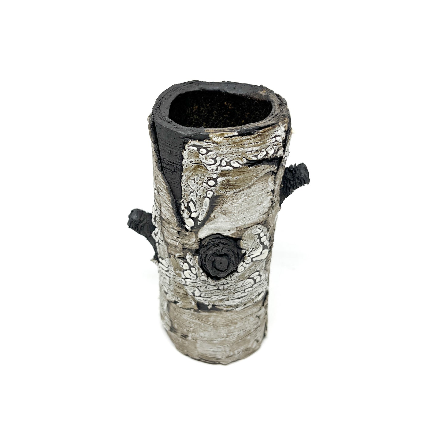 A cylindrical vase resembling birch bark with a textured surface, featuring black and white elements and two protruding branch-like details.