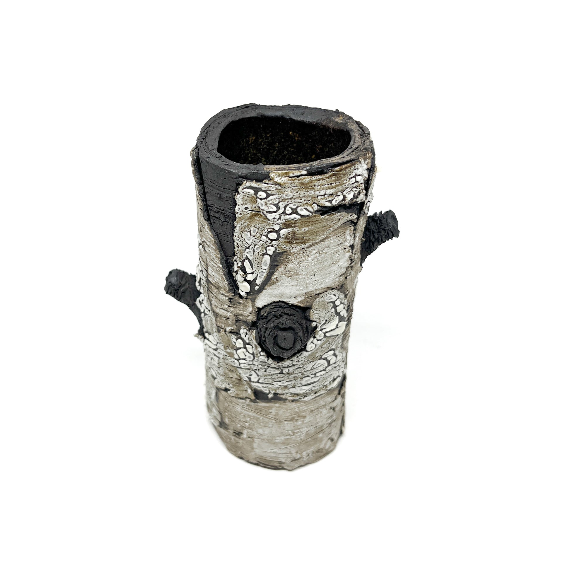 A cylindrical vase resembling birch bark with a textured surface, featuring black and white elements and two protruding branch-like details.