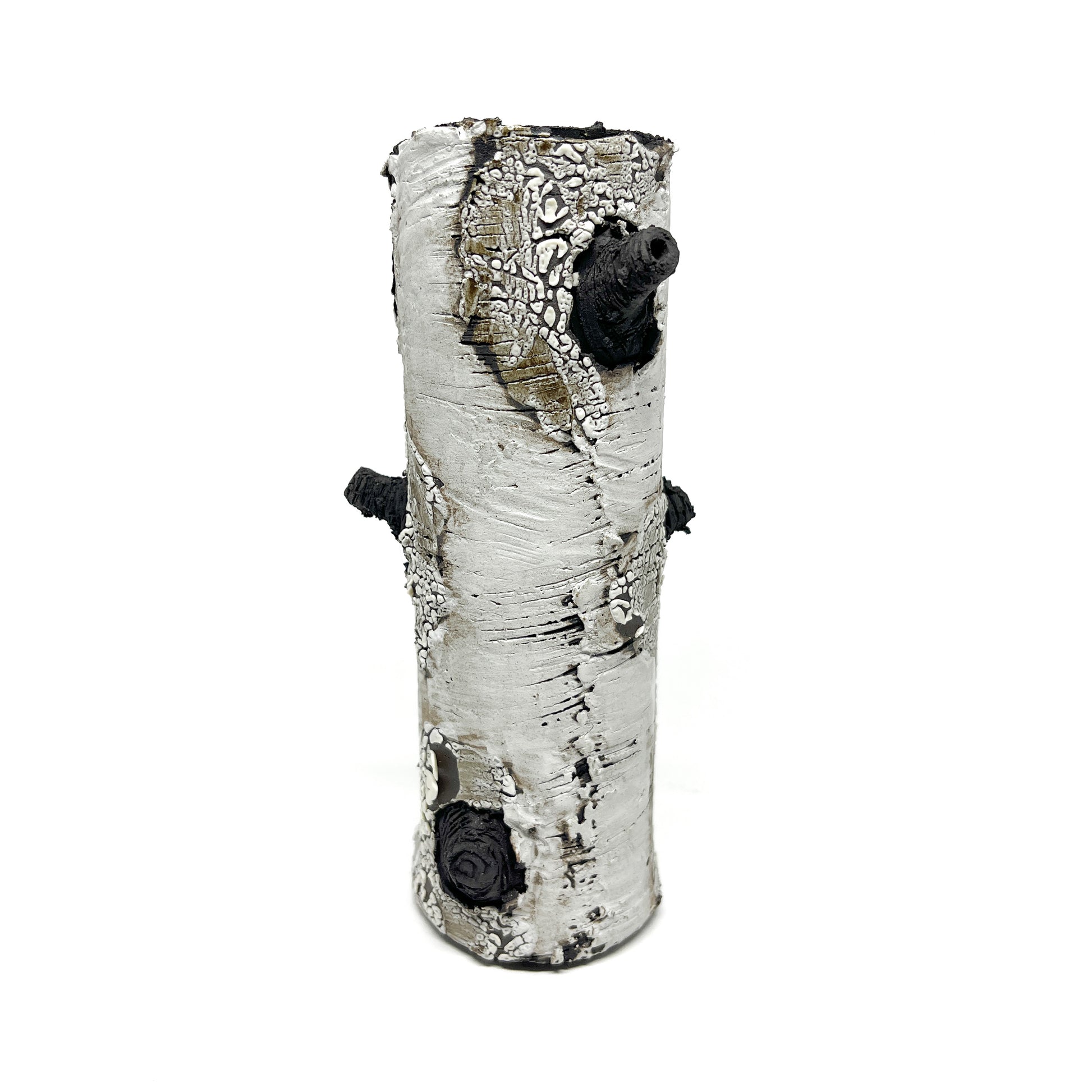 A cylindrical vase resembling birch bark with a textured surface, featuring black and white elements and two protruding branch-like details.