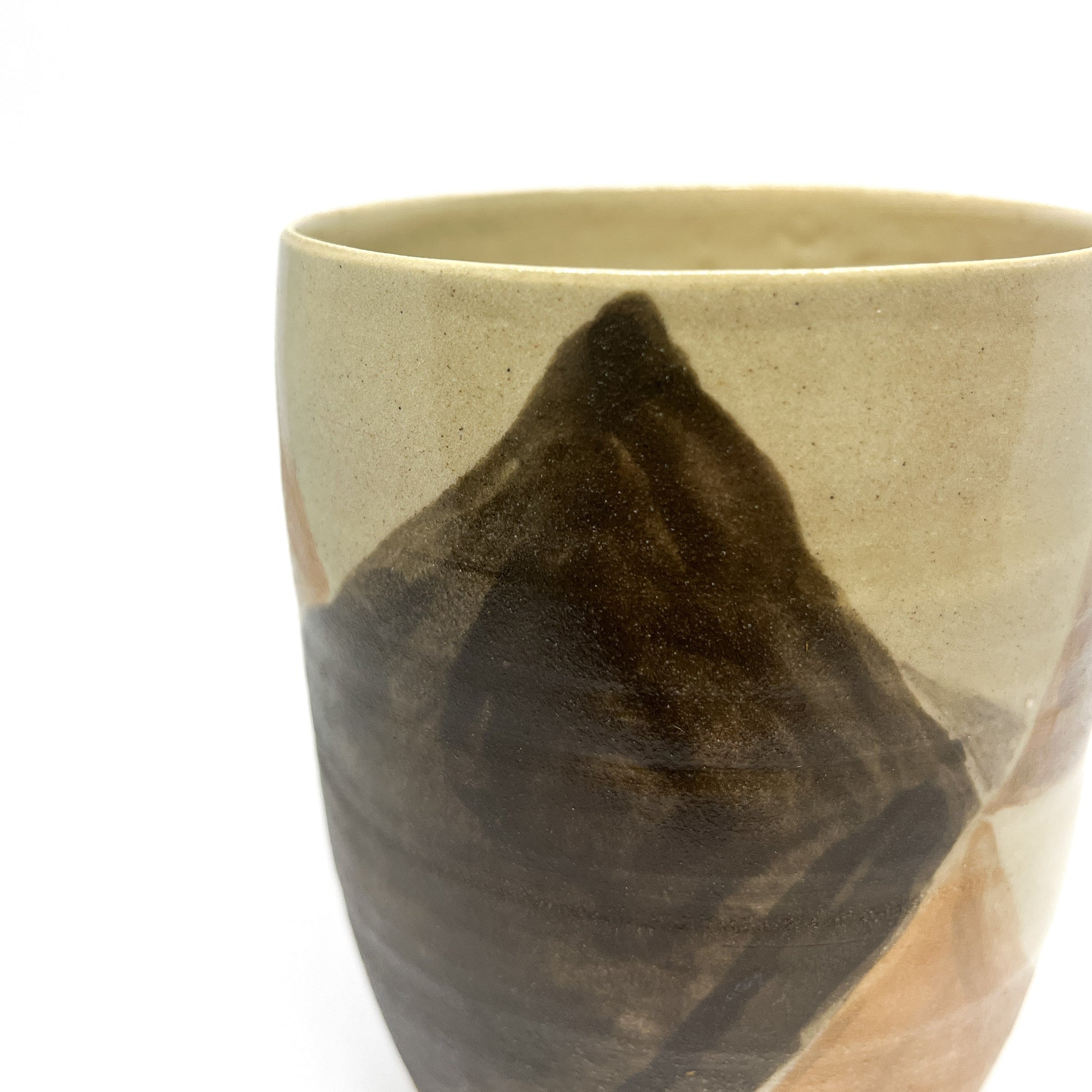 Close-up of a Bizen ware vase with abstract, naturally fired markings in earthy shades.