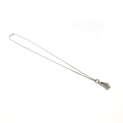 Full view of a delicate silver chain necklace featuring a small abstract pendant.