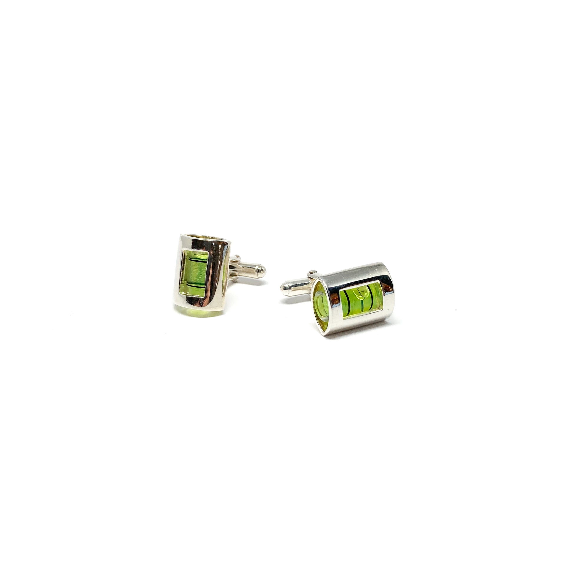 A pair of silver-toned MRCUFF Level Green Liquid Construction Cufflinks with miniature spirit levels containing bright green liquid and air bubbles.