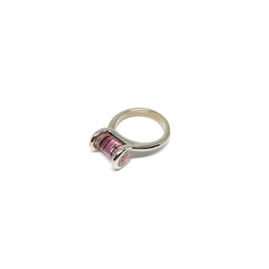 Silver ring featuring a miniature bubble level with pink liquid and a centered clear bubble.