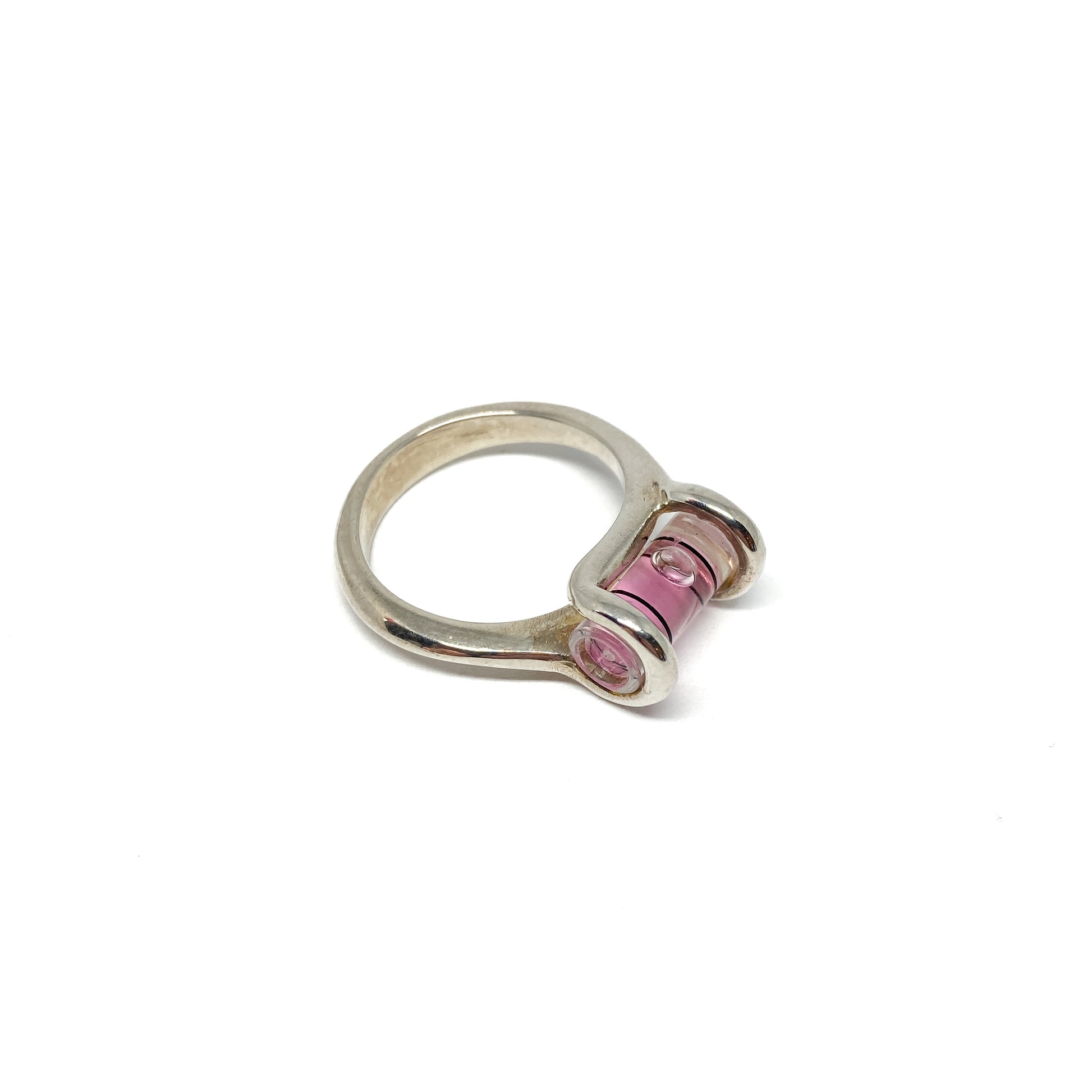 Silver ring featuring a miniature level with pink liquid and a clear bubble slightly off-center.