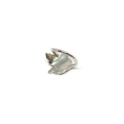 A shiny silver ring with a detailed maple leaf design is shown at an angle.