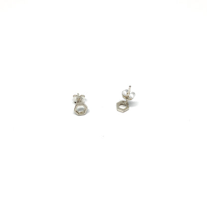 Two shiny silver stud earrings, each a small open hexagon with a post and butterfly back, are shown.