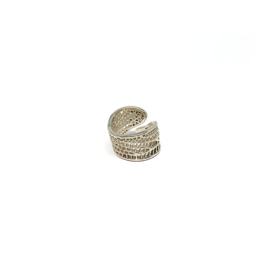 A shiny silver ring with a detailed cut-out design resembling a dragonfly wing is shown.
