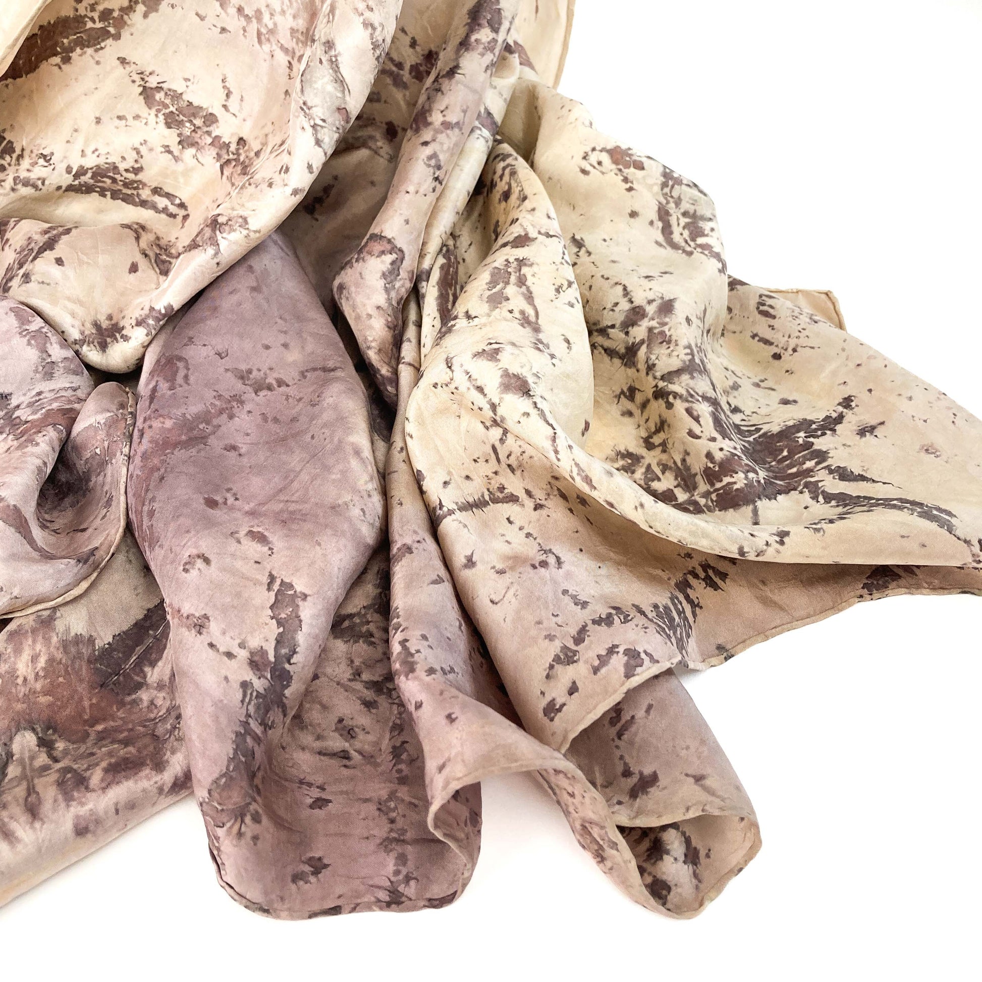 Close-up of Silk Blanket Scarf highlighting the fluid drape and botanical print with natural dye effects.
