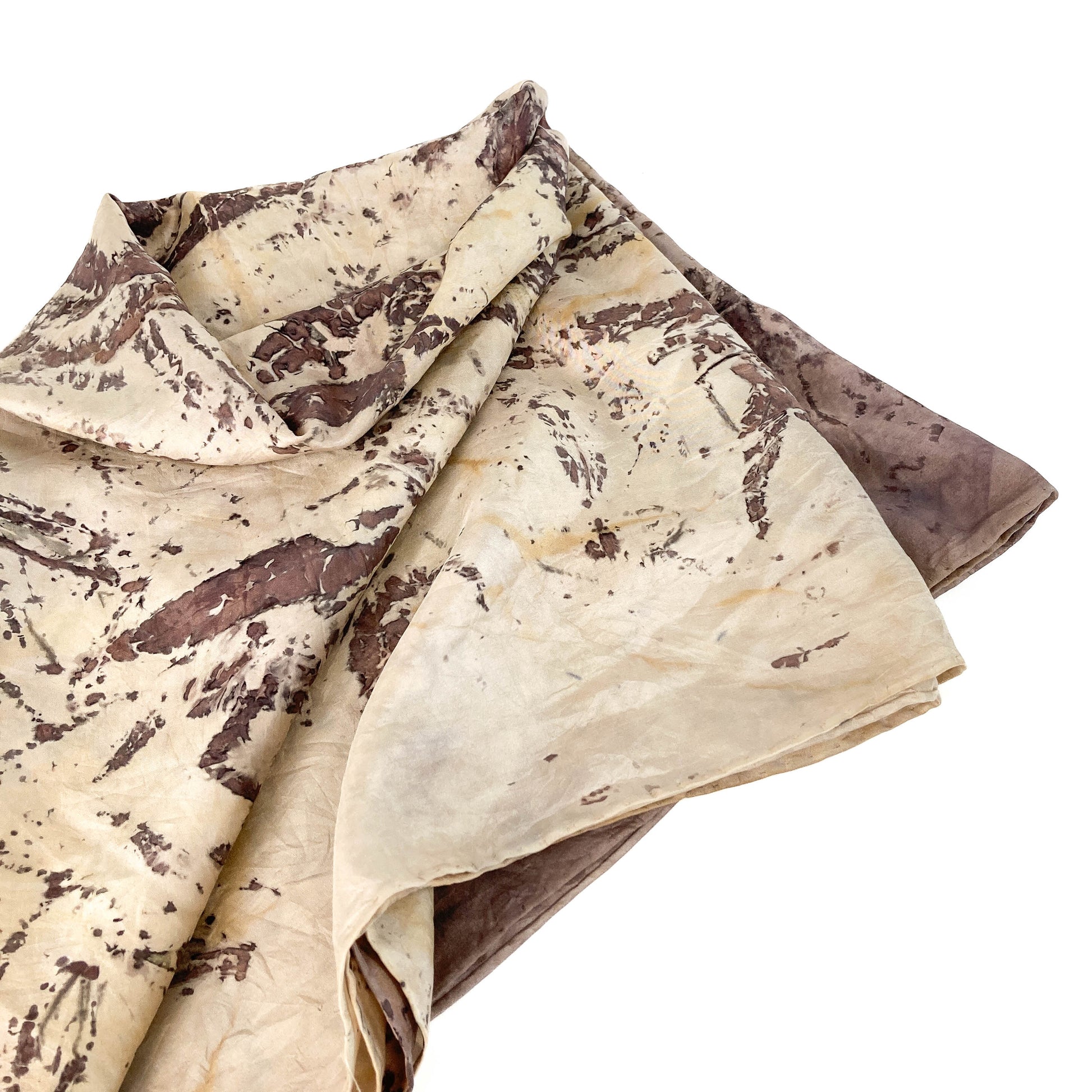 Folded Silk Blanket Scarf showing detailed organic prints and subtle variations in tone and texture.