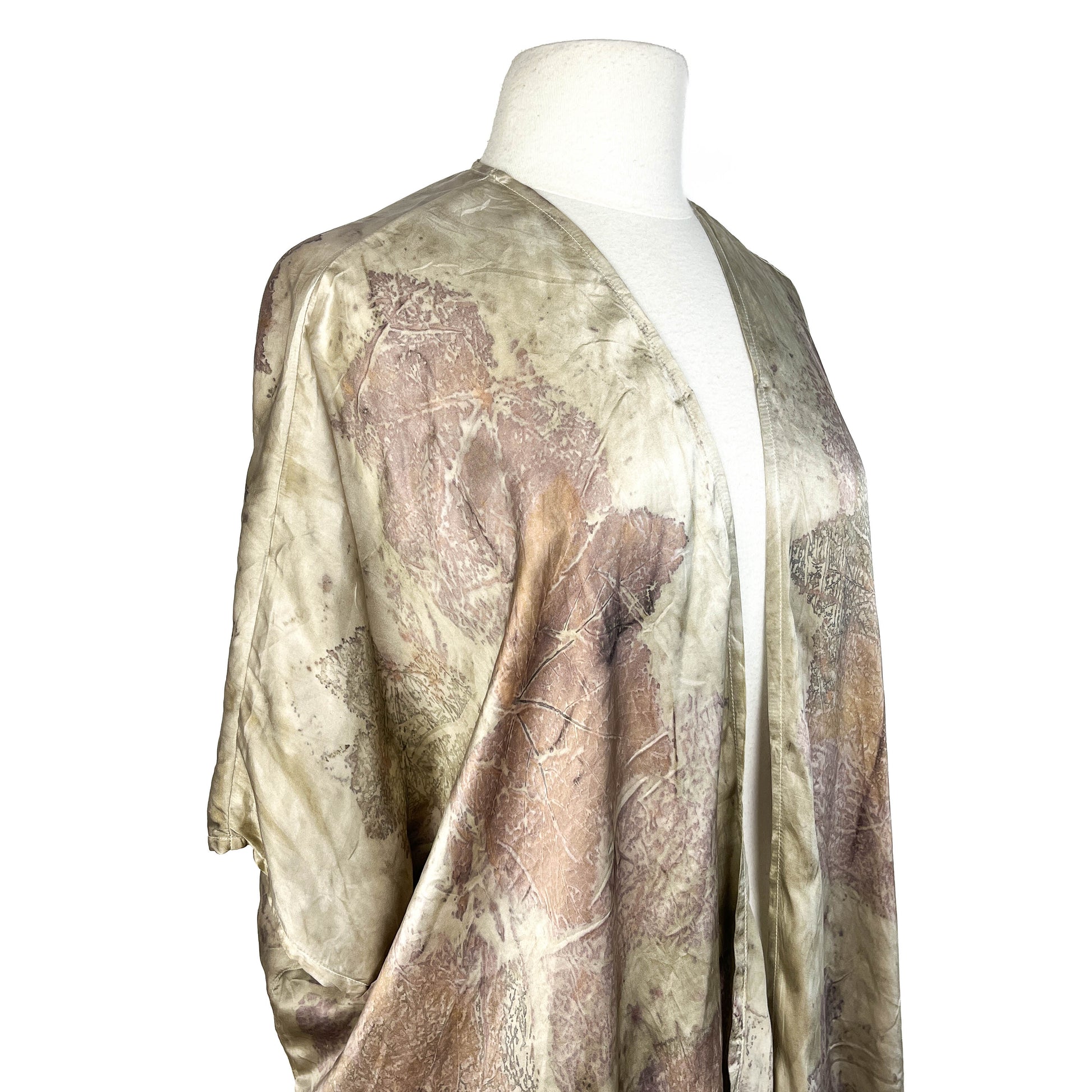 Angled view of Short Silk Cardigan highlighting soft texture, flowing silhouette, and leaf patterns.