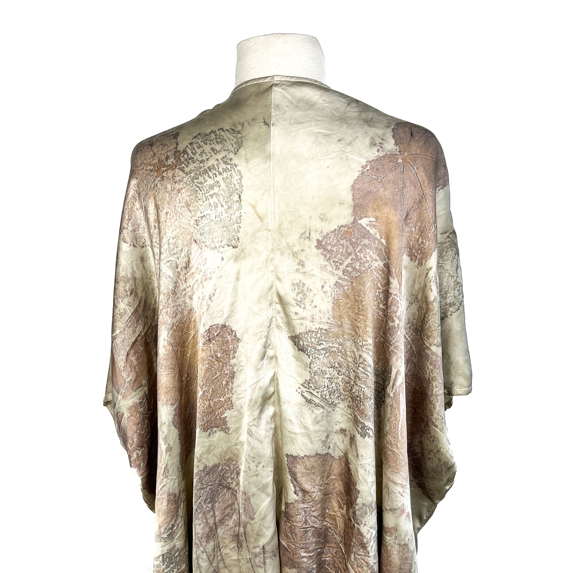 Back of a Short Silk Cardigan featuring natural leaf prints and soft folds in a relaxed silhouette.